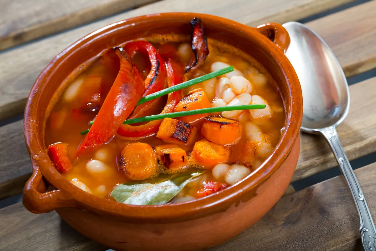 Bob chorba in a clay pot: white beans, carrots and roasted red peppers in a tomato broth, with chives and a bay leaf.
